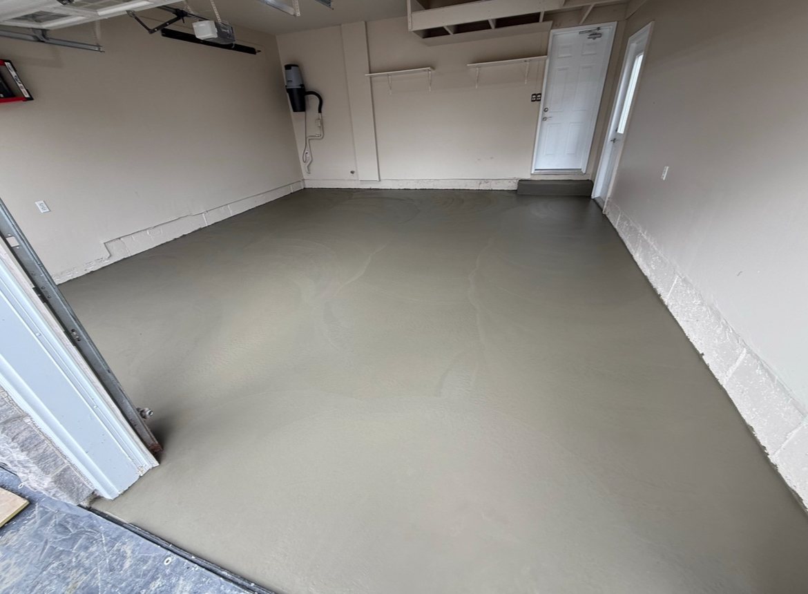 A worn Toronto garage slab repaired and resurfaced back to a flat, uniform floor, wall to wall